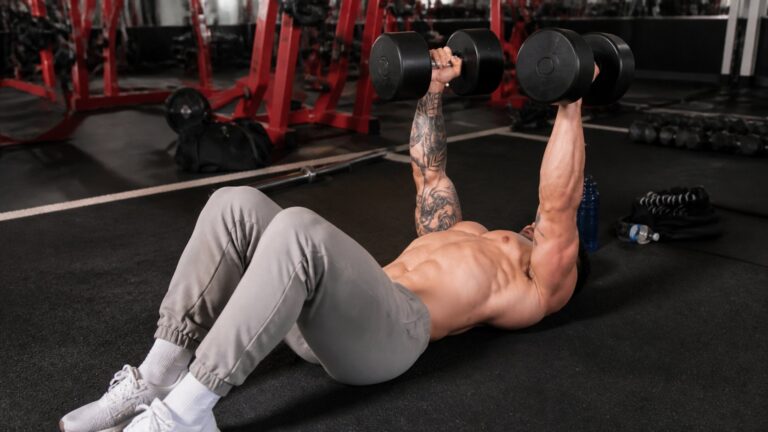 Dumbbell floor press in a strength gym