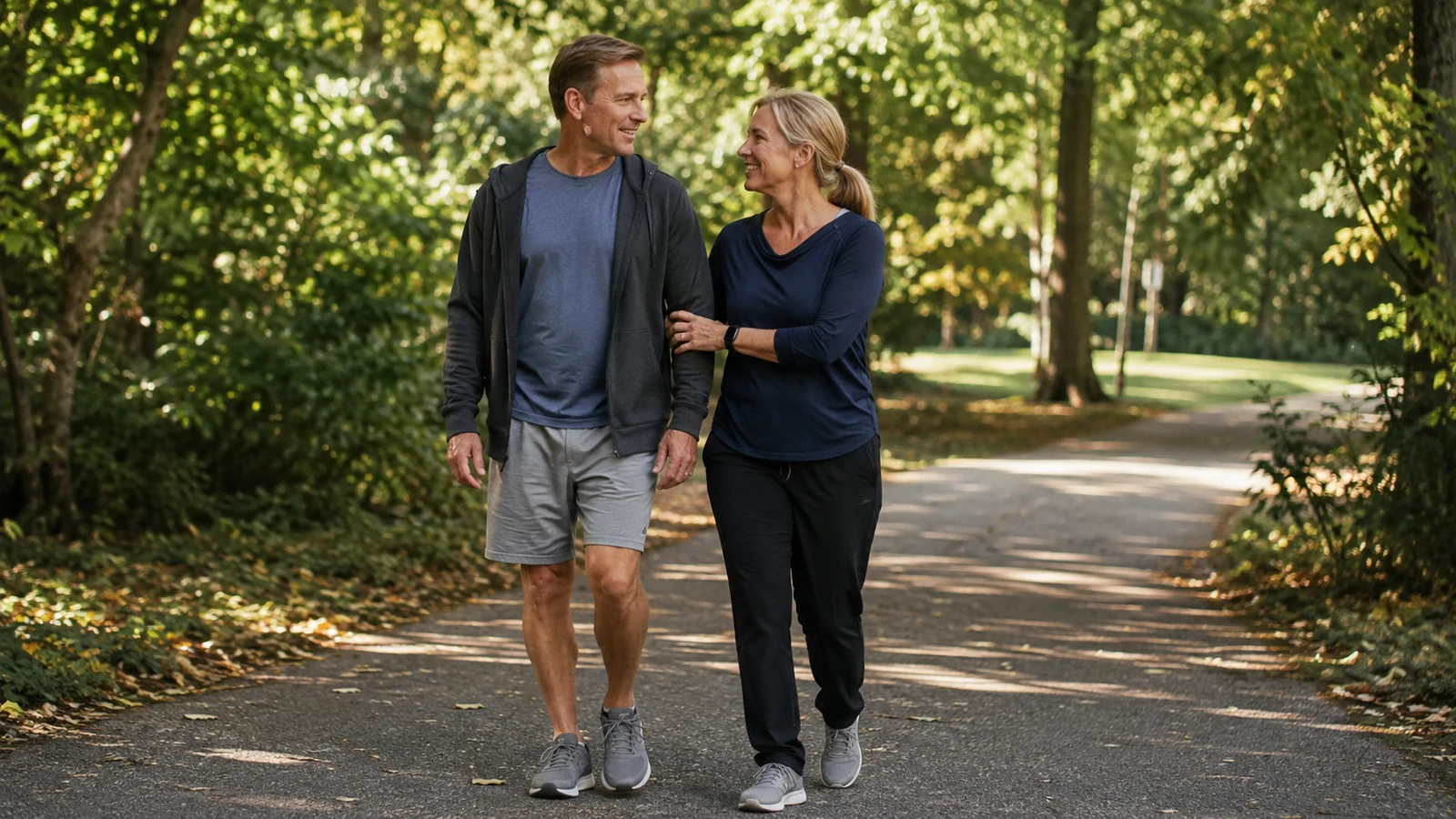 Anonymous middle-aged man taking a gentle outdoor walk with a supportive companion during recovery