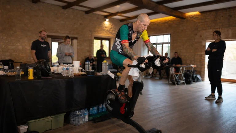 An endurance cyclist pedals a stationary bike during an extreme indoor cycling record attempt