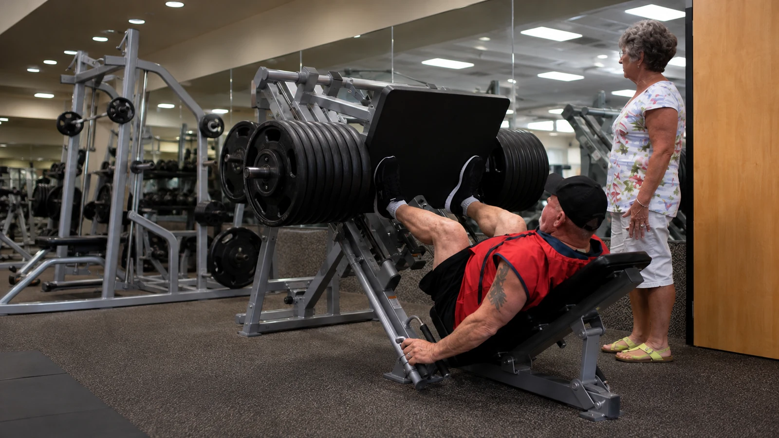 Bruce Klein performing high-repetition leg presses on a plate-loaded machine