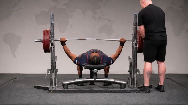 Devin Williams completing a raw bench-press attempt on an IPF platform.