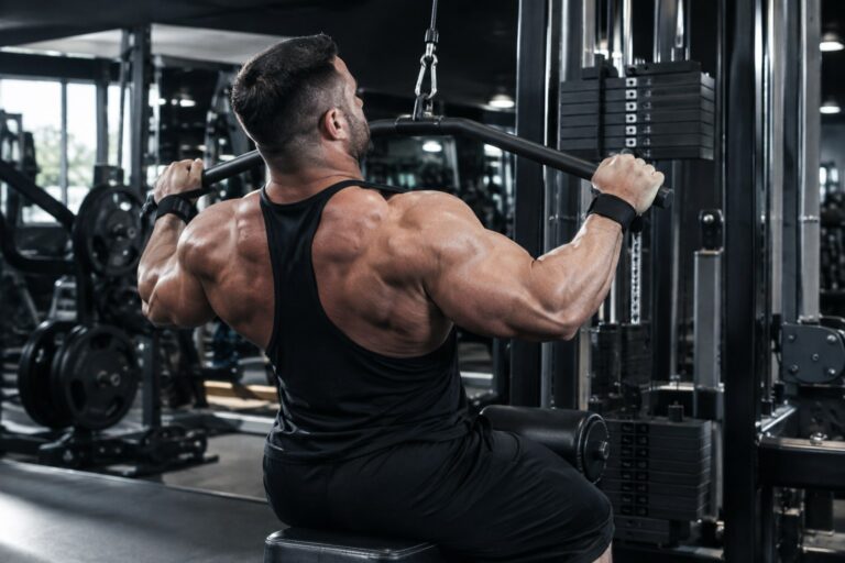Elite bodybuilder performing a controlled back workout in a professional gym