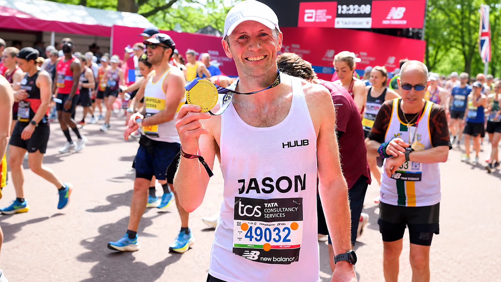 Facebook-derived photograph of Jason Kenny holding his marathon finisher medal.