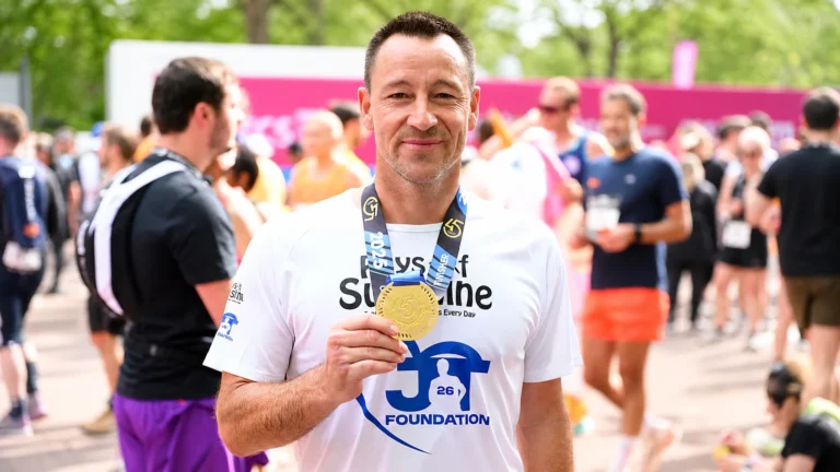 Facebook-derived photograph of John Terry holding a marathon medal.