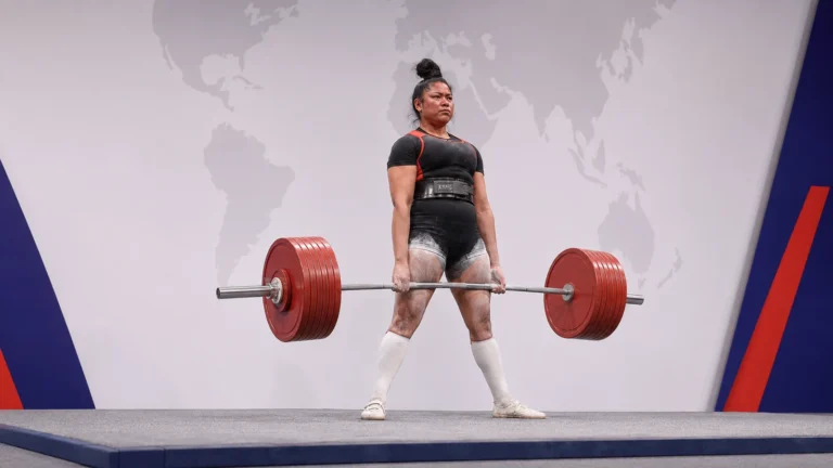 Editorial recreation of Ziana Azariah locking out a heavy deadlift on an international competition platform.