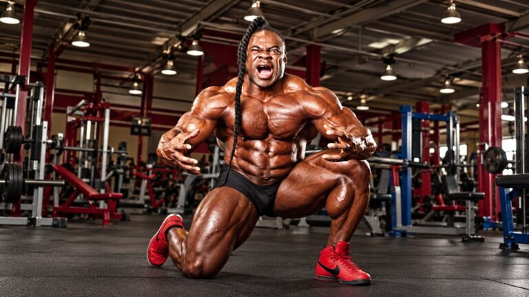 Kai Greene posing in a gym, in a cleaned editorial adaptation of the scheduled Facebook post photo