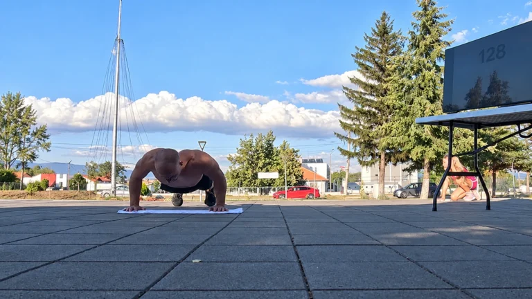 Michael Donchev performing a push-up on a white towel at the outdoor record venue, restored from the original source frame.